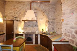 a kitchen with a stone wall and a sink at La Casina Colorata in Assisi +87 photos
