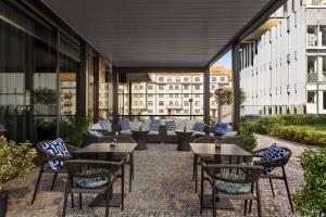 a patio with tables and chairs on a building at Vienna House by Wyndham Diplomat Prague in Prague