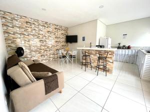 sala de estar y cocina con sofá y mesa en Recanto da Ivete en São Sebastião