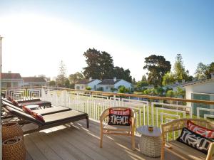 a deck with chairs and tables on a house at Boho Club in Marbella
