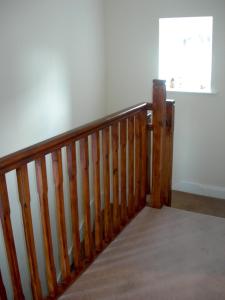 a wooden staircase in a room with a window at Templemoyle Farm Cottages in Campsey