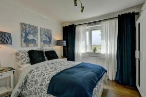 a bedroom with a large bed and a window at Pippins in Tiverton