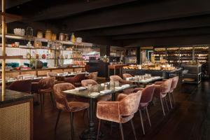 a restaurant with tables and chairs and a bar at Boho Club in Marbella