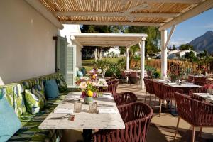 an outdoor dining area with tables and chairs at Boho Club in Marbella