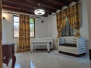 a room with two beds and two windows at Cocobongo Beach Lodge in Dar es Salaam