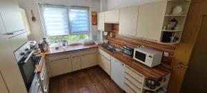 a kitchen with white cabinets and a microwave at Modern townhouse, quiet and close to the centre. in Berlin
