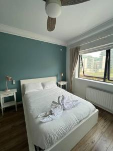 a bedroom with a bed with swans on it at Stylish Flat With River View in Dublin