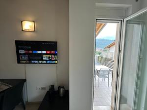 a room with a sliding glass door leading to a balcony at 4 Limoni Apartment Resort in Riva del Garda