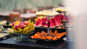 a buffet with several plates of food on a table at Hotel Bizzon in Jequié