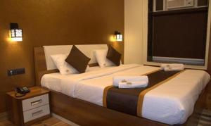 Postel nebo postele na pokoji v ubytování FabHotel Prime Tiyara Inn