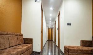 a hallway with two couches in a building at FabHotel Prime Tiyara Inn in Kolkata