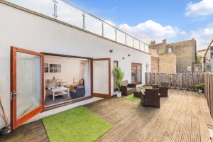 an apartment balcony with a deck with green grass at The Waterloo Apartment - Large Private Patio & Air Conditioning in London
