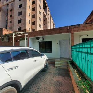 a white car parked in front of a house at Private Suite F-10 Islamabad in Islamabad