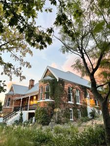 an old brick house with ivy growing on it at Flash Jacks of Gundagai in Gundagai