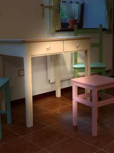 a desk with a stool and a table with a chair at The Dachshund's Chateau in Budíkov