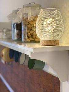a white shelf with a jar of food on it at The Dachshund's Chateau in Budíkov +8 photos