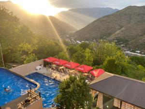 a view of a swimming pool with mountains in the background at Grand Hotel Kapan, Armenia in Kapan