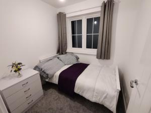 a small bedroom with a bed and a window at Cosyhome in Wellingborough