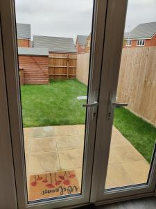 an open door with a view of a yard at Cosyhome in Wellingborough