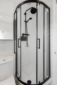 a shower with a glass door in a bathroom at Tranquil 1 Bed Flat in East London in London