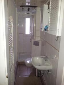 ein Bad mit einem Waschbecken und einem WC in der Unterkunft Ferienwohnung "Am Vaterlandsgrubenweg" - a57586 in Oelsnitz