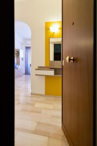 a door leading into a kitchen with a yellow wall at Elide - Love Locks in Ponte Milvio in Rome