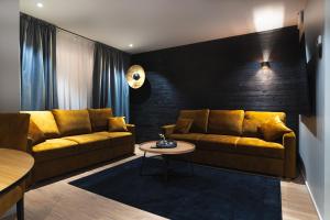 a living room with two couches and a table at Royal Roi Apartments in Rovaniemi