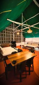 a wooden table in a room with a green tent at Angel Heritage Home - Serenity Beach, Pondicherry. in Puducherry