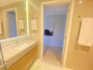 a bathroom with a sink and a mirror at Studio no Setor Marista 660 in Goiânia