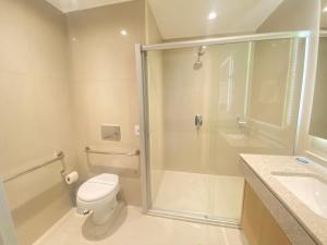 a bathroom with a shower and a toilet and a sink at Studio no Setor Marista 660 in Goiânia
