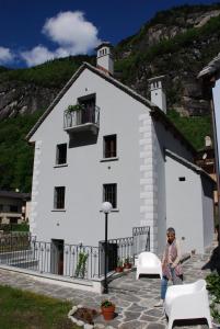a woman standing in front of a white building at Il Borgo Antico in Cadarese