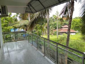 a balcony with a view of a house at Somatheertham Panchakarma Resort in Kovalam