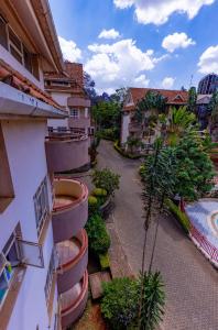 an apartment building with balconies and a courtyard at Cosy and accessible 1BR penthouse with terrace in Nairobi
