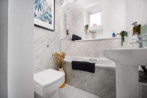 a white bathroom with a sink and a toilet at Bijoux Central Plymouth 1 Bedroom Apartment - Sleeps 5 - Habita Property in Plymouth