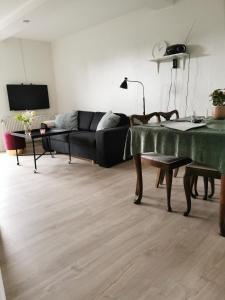 a living room with a couch and a table at Håstrups Natur Perle in Fåborg