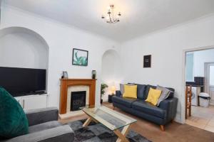 a living room with a couch and a fireplace at Beautiful 3 Bed Abode in The Heart of Skipton in Skipton