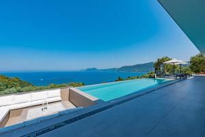 a swimming pool with a view of the water at Villa Anthelia in Pentátion