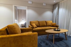 a living room with a couch and a table at Royal Roi Apartments in Rovaniemi +62 photos