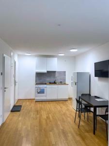 a room with a kitchen and a table and a table and chairs at Vienna´s Danube Apartments in Vienna