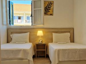 Posteľ alebo postele v izbe v ubytovaní Panorama Apartments Fiscardo