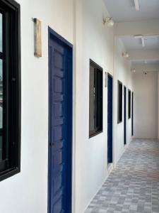 a blue door on the side of a building at Art Nara Hotel อาร์ตนรารีสอร์ท in Narathiwat +22 photos