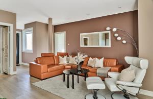 a living room with a couch and a chair at Queen's Cave By Staysville in Stavanger
