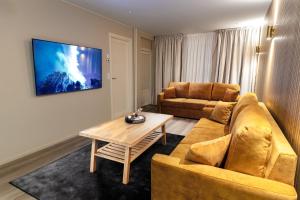 a living room with a couch and a table at Royal Roi Apartments in Rovaniemi