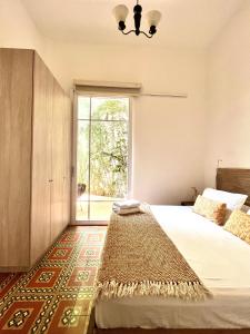 a bedroom with a large bed with a large window at Casa Rambla Serra Cali in Cali