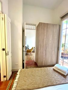 a room with a bed and a cabinet in it at Casa Rambla Serra Cali in Cali