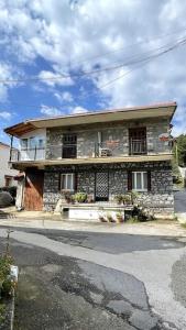 a stone house on the side of a street at Loukia's Place in Vitina