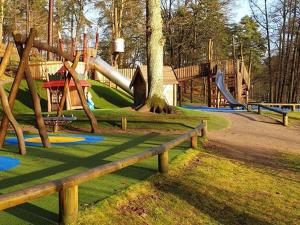 a park with a playground with a slide and slides at independent apartment near citycenter/lake in Borås