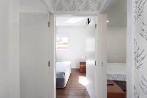 a bedroom with a bed and a room with a door at Moradia Pinheiro Manso in Apúlia +32 photos