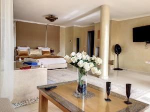 a living room with a vase of flowers on a table at Dar De Santis in Azemmour