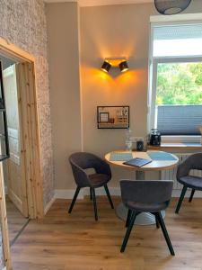 a room with a table and chairs and a window at Katharina Boardinghouse in Osnabrück